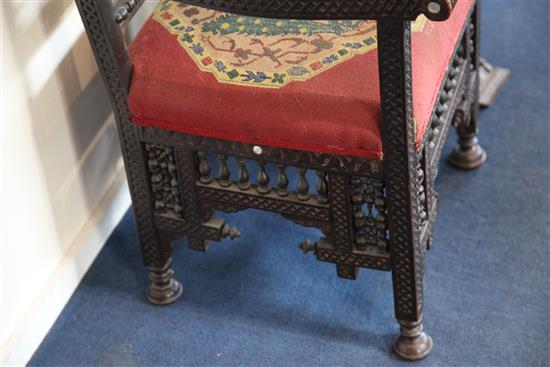 A late 19th century moorish open armchair and a similar armchair